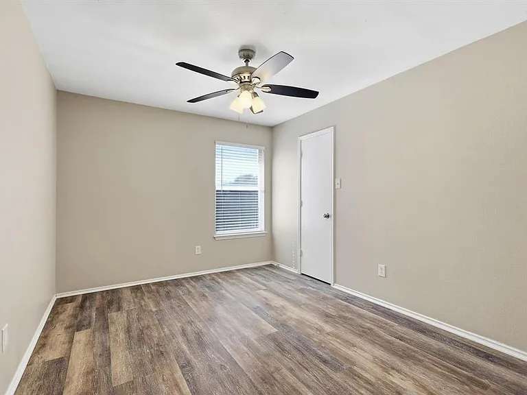 Spare room featuring wood finished floors and ceiling fan