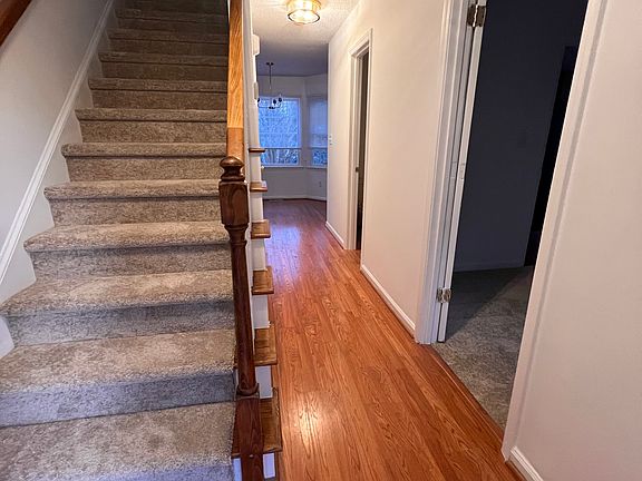 Front entrance leading to stairs and room downstairs that can be used for bedroom, office/study or dining room.