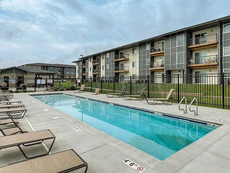 Take a dip or soak up the sun_our long lounge pool and sundeck make outdoor relaxation easy and inviting.