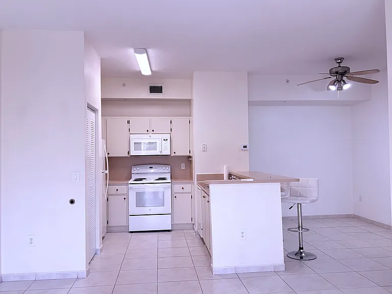 ample kitchen with counter and stools