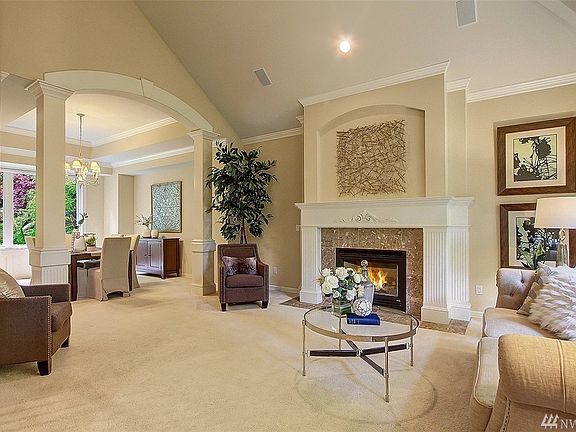 The formal living room also enjoys very tall ceiling height, crown molding and marble surround gas fireplace. 