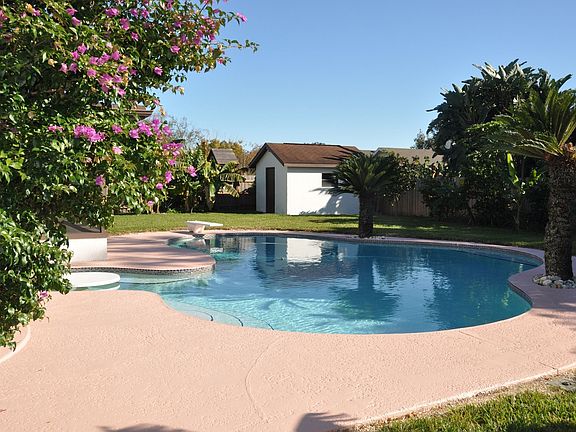 View of pool and separate house in back