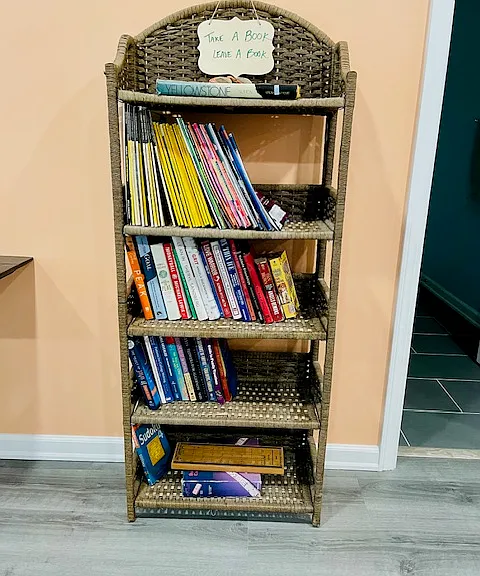 Book shelf with magazines, books, games to use.