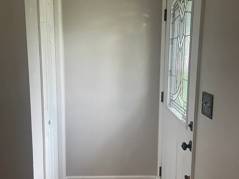 Front door - view from living room, entrance/coat closet on the left.