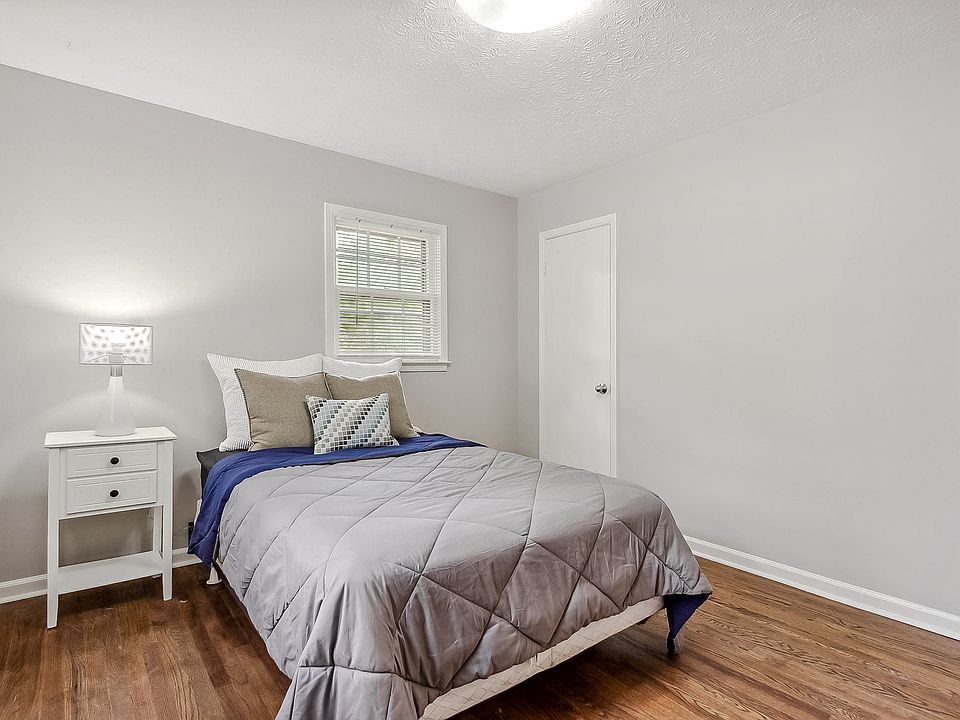 Room 2 with full size bed, nightstand and lamp