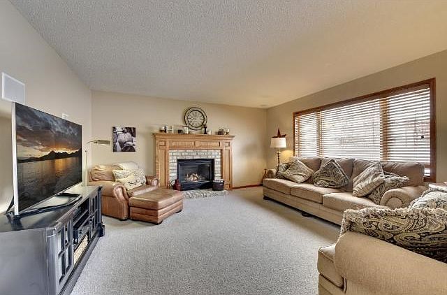 Spacious great-room w/ gas burning fireplace and custom mantle.