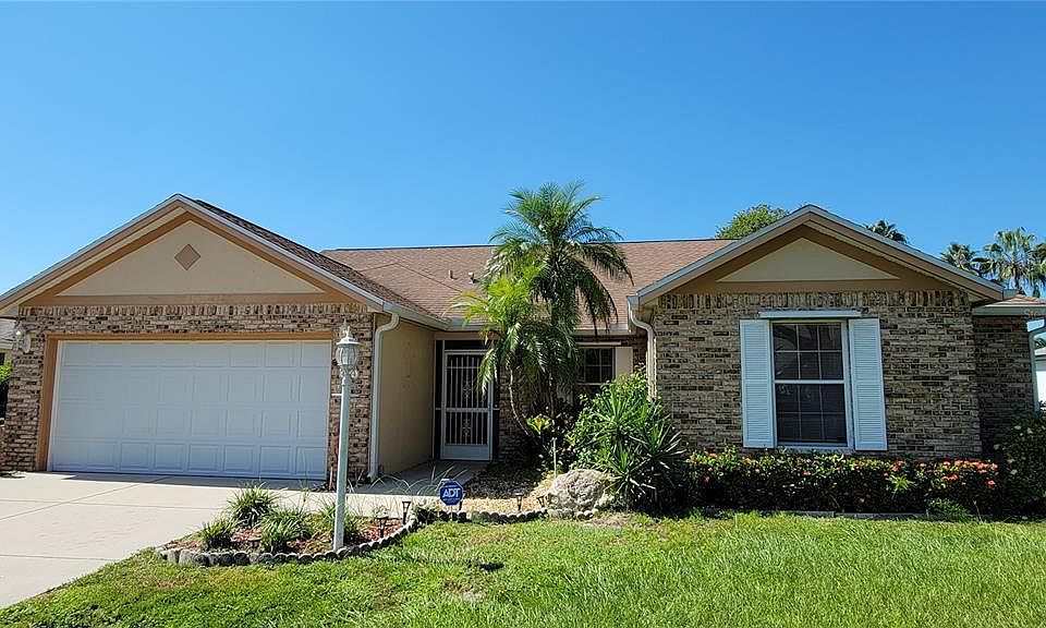 Front with brick exterior & 2-car garage