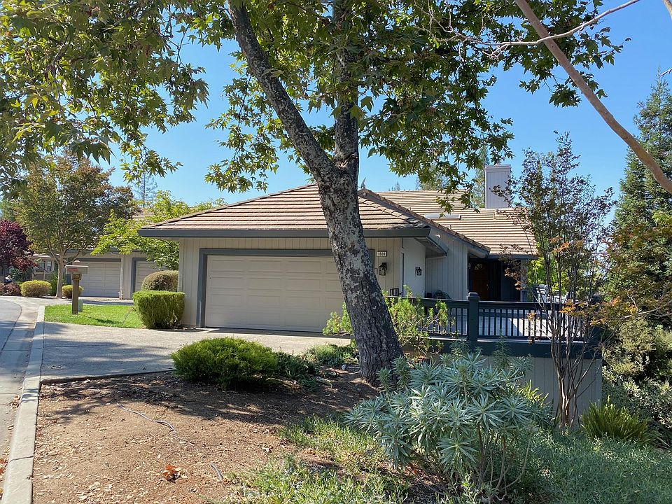 Attached two-car garage with front door entrance deck