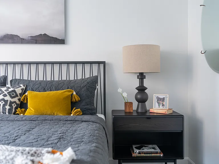 Spacious apartment bedroom with wood-style flooring.