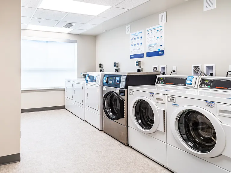 Laundry Room with 3 washers and 3 dryers. Payment card operated (no coins), with mobile app integration for load update, payment, and support features.