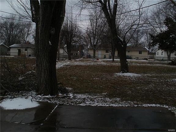 Additional view of partially fenced shaded back yard.