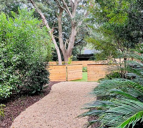 Welcoming path to the backyard garden. Planting bed on either side are full of 18 year old ferns, azaleas, camillas, etc.