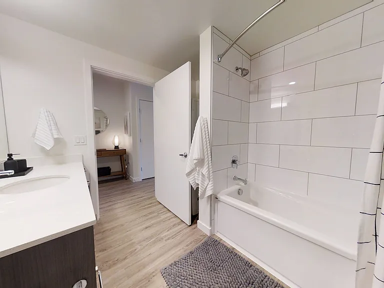 Upscale bathroom featuring large ceramic tile surround