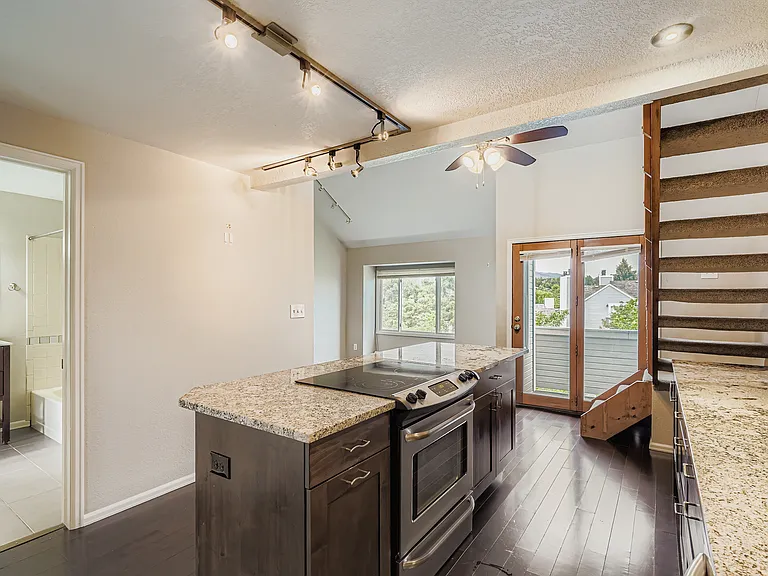 Your first sight is the remodeled kitchen with updated lighting, open to the living room and views.