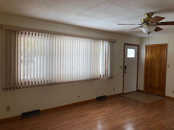 Living room with tiled entryway, and front closet.