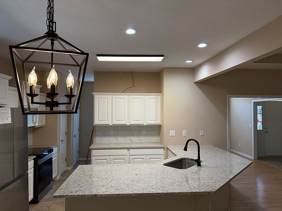 Updated kitchen with brand-new pendant light and modern LED rectangular light
