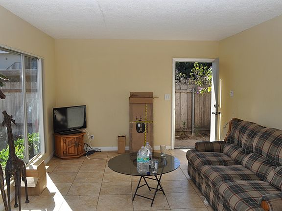 Living room with view toward front door, (please excuse mess)