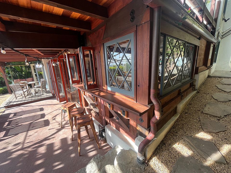 lower level from the exterior via entryway path, view of kitchen windows and patio