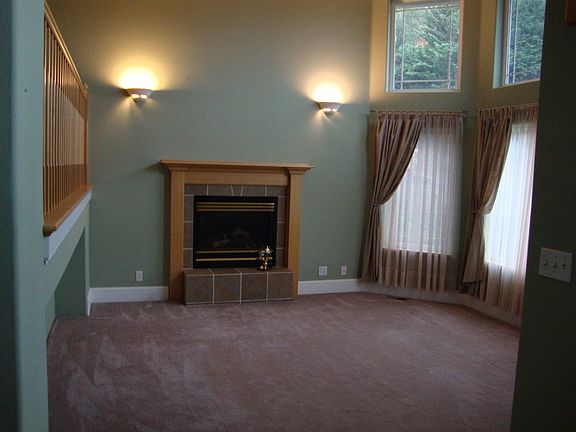 Living room with gas fireplace, large windows and lots of light!