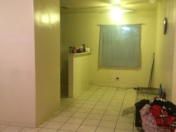 The living room connects with the dining room