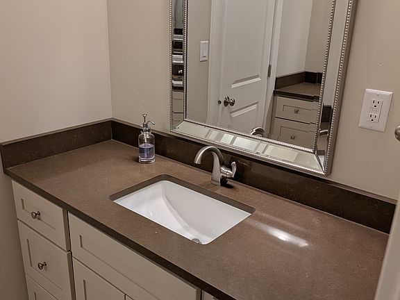 Bathroom with double sinks, tub with shower.