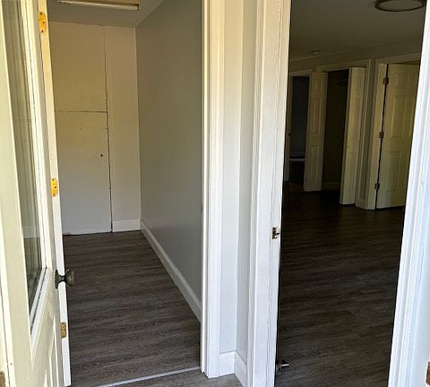 Enter into a small mudroom. Ahead is a private utility room. Entrance to the living room is to the right.