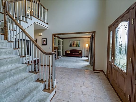 Enter the open and bright two story foyer flanked by the dining room and formal living room.