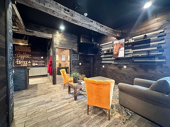 From the moment you enter, you're welcomed by warm wood tones, rich textures, and unique detail with the exposed barn beams and slate stone accent wall.