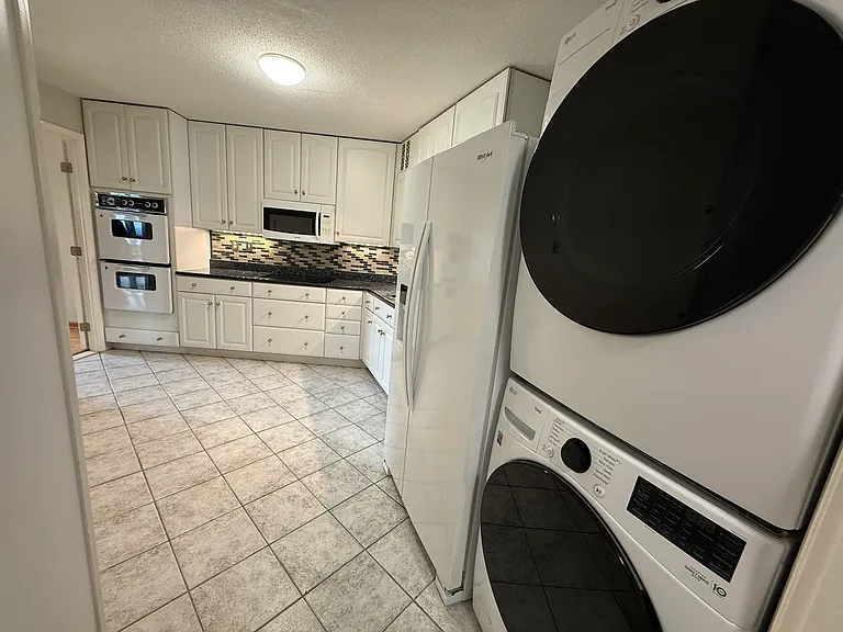 Kitchen with new refrigerator and washer/dryer