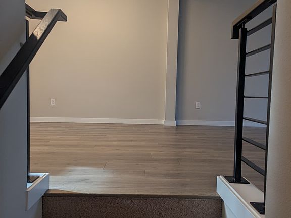 Stairs from entryway leading to the open dining space.