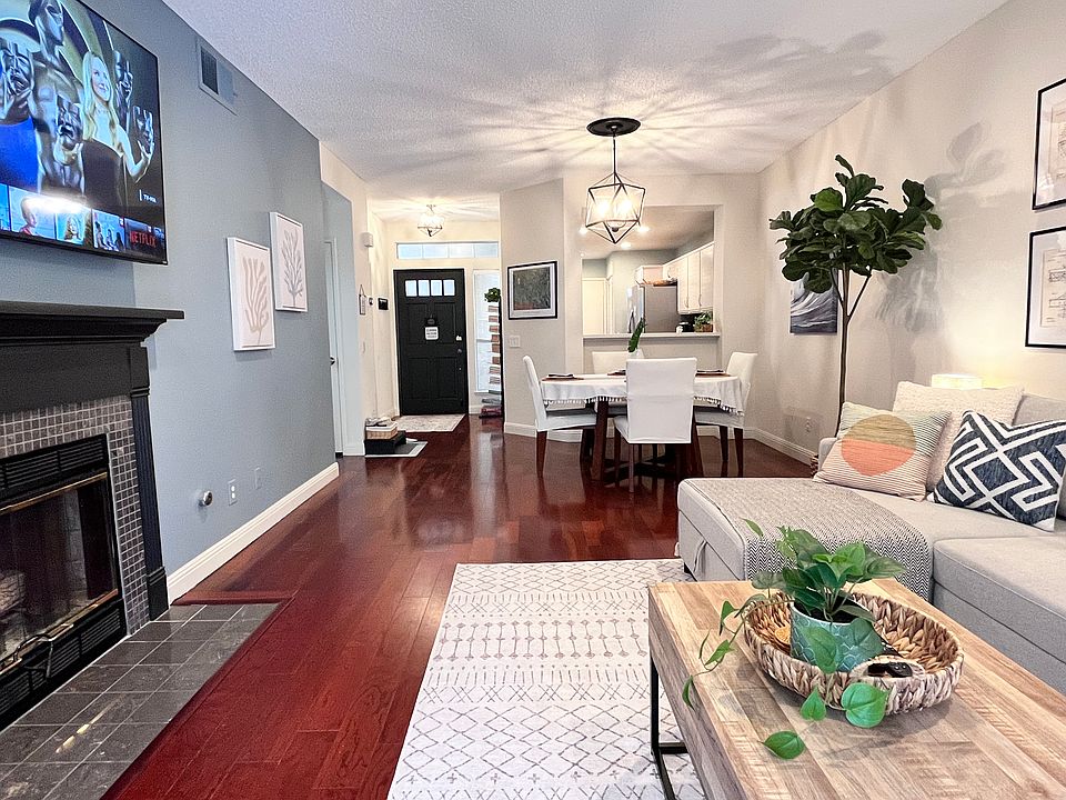 Living Room with Smart TV, Fireplace, Dining Room, and view of Kitchen