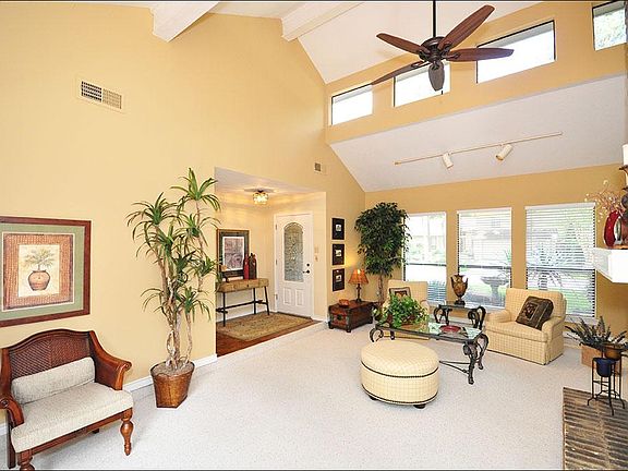 High ceilings enhance this living room, making it light and airy.  The home is complete with a touch screen alarm and smoke detection system, hard wired (no batteries) that is prepaid for 2 years!