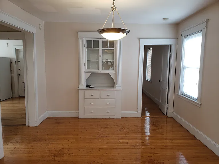 Dining room with beautiful pendant light and gleaming hardwood floor