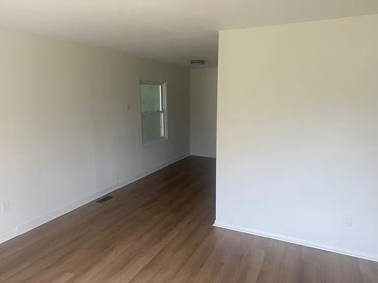 Picture taken from front room, looking into an eat-in area, kitchen is around the corner