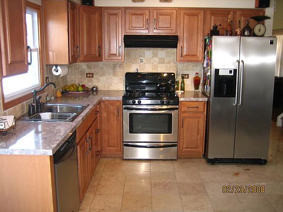 large eat -in kitchen, new maple cabinets, new stainless steel appliances