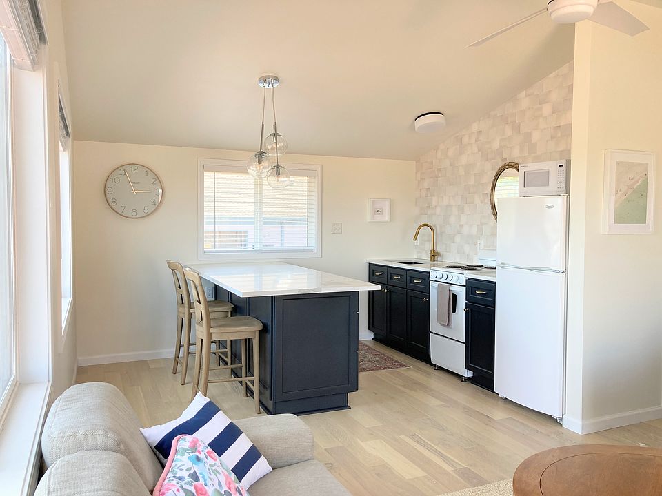 Studio loft with designer finishes, open kitchen with large island with quartz countertops.