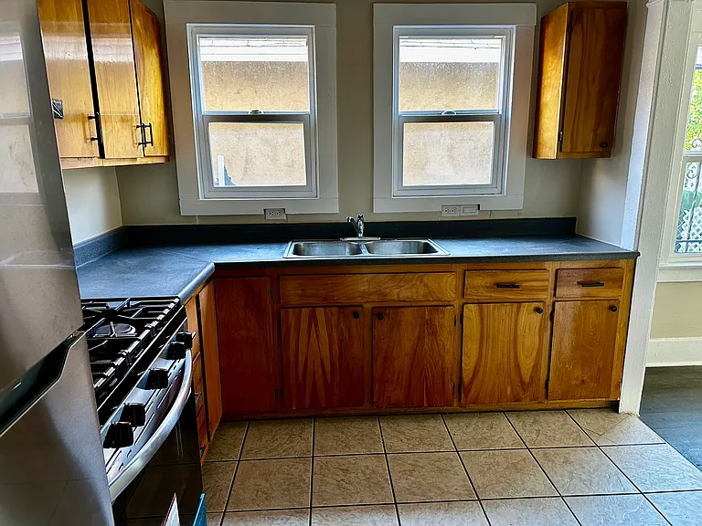 Beutiful kitchen with lots of wood cabinets for storage and cooking.