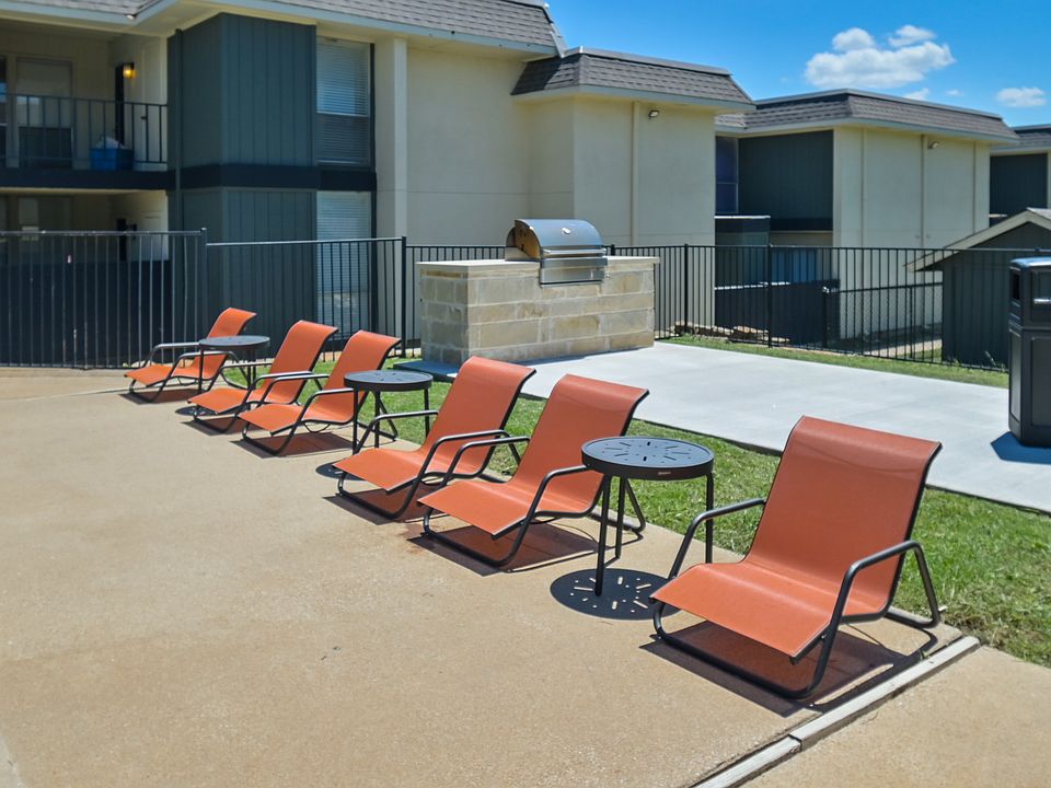Outdoor seating area with shaded pergola and gathering space