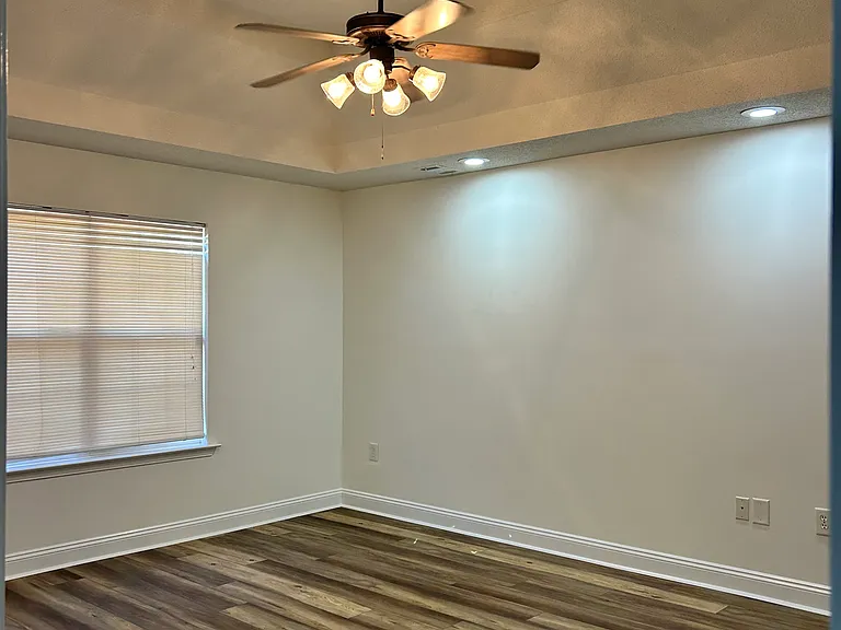 Master Bedroom with tray ceiling, ceiling fan, and recessed lighting.