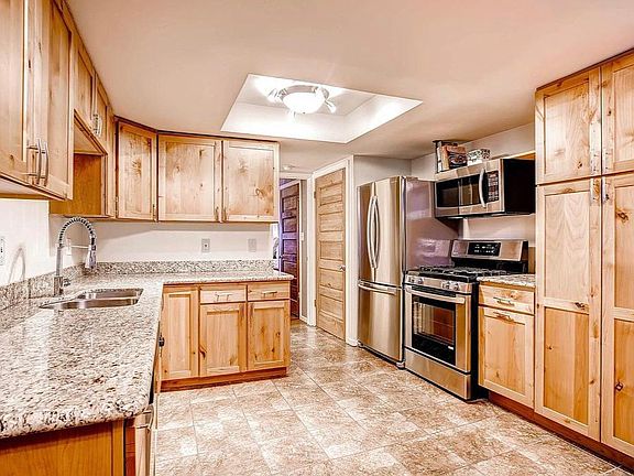 Ample storage in kitchen with gorgeous granite countertops and new stainless steel appliances.