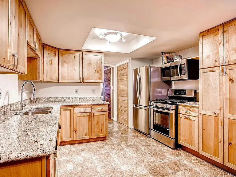 Ample storage in kitchen with gorgeous granite countertops and new stainless steel appliances.