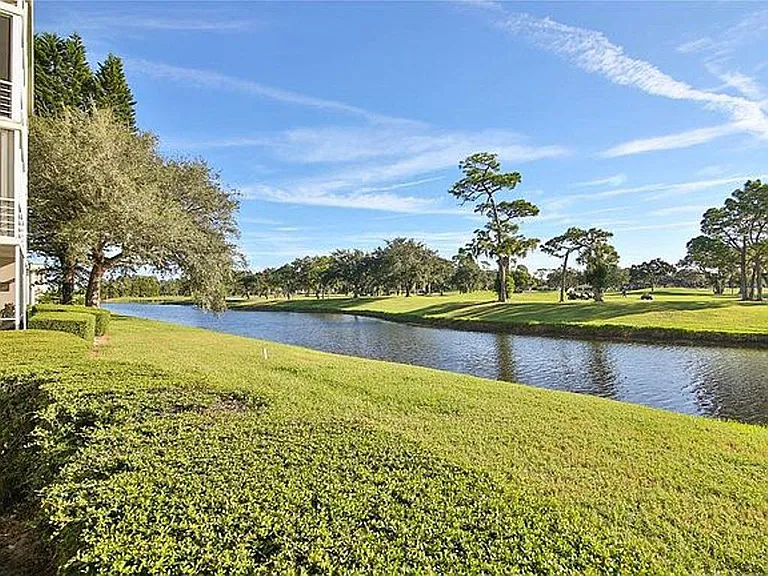 Northerly ground view from rear of building beyond canal and golf course.