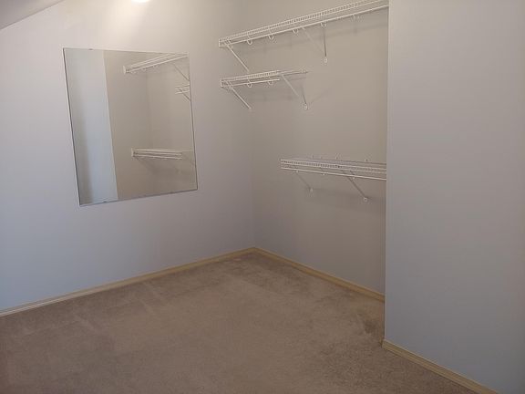 Master walk-in closet. Room measures approximately 13ft 10in x 9 ft 6 in.
