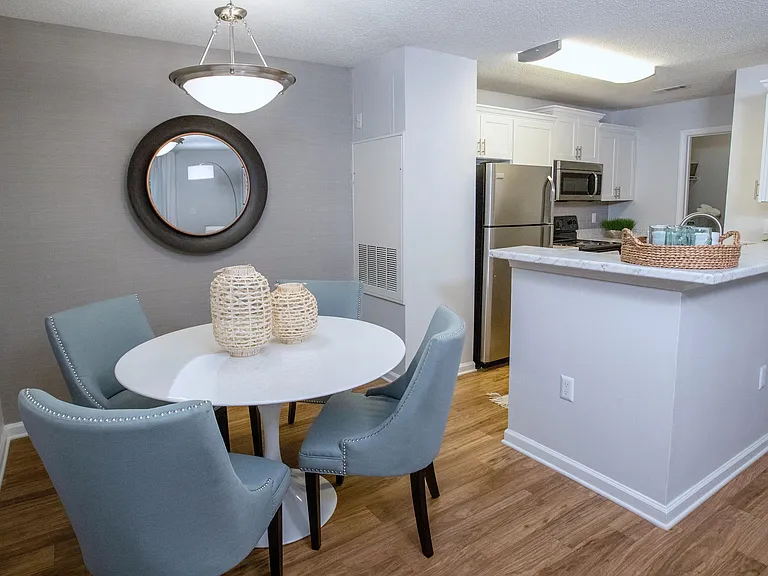 Dine in style at Emerson Isles with dining rooms featuring a modern chandelier, and a seamless flow into your upgraded kitchen and open living space.