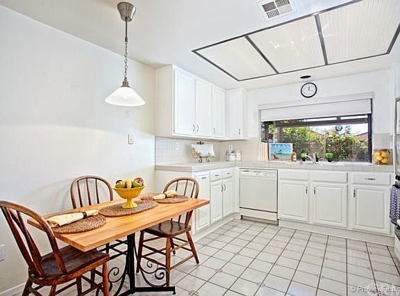 Bright and cheery kitchen with garden window looking onto the patio and breakfast nook area.