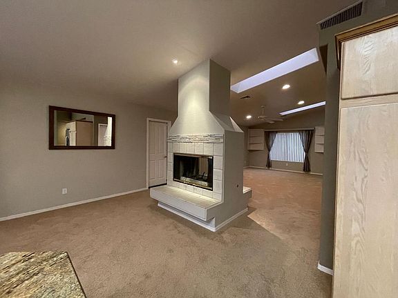 dual sided fire place separates the kitchen/dining area from the large family room