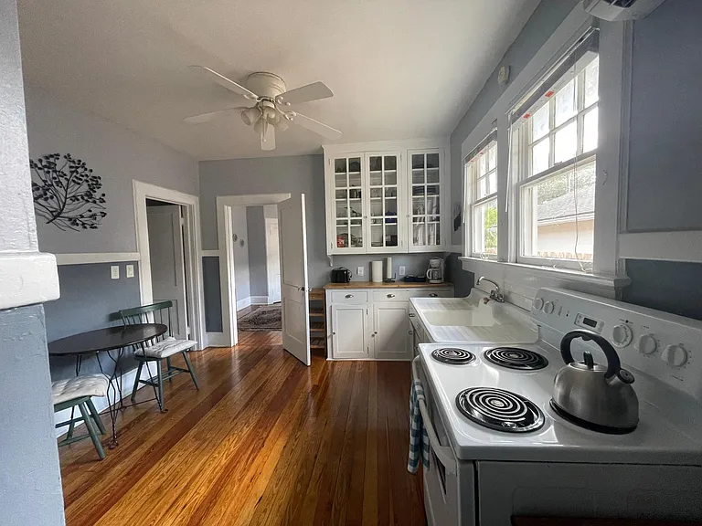 View from the back of the kitchen to see storage for dishes, pots and pans, etc.