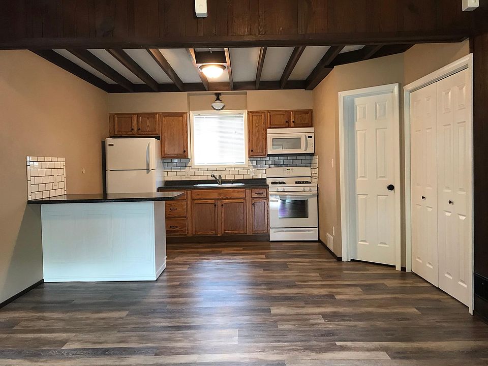 Kitchen, with door to furnace room (with some storage area) and a closet that extends under the stairs.