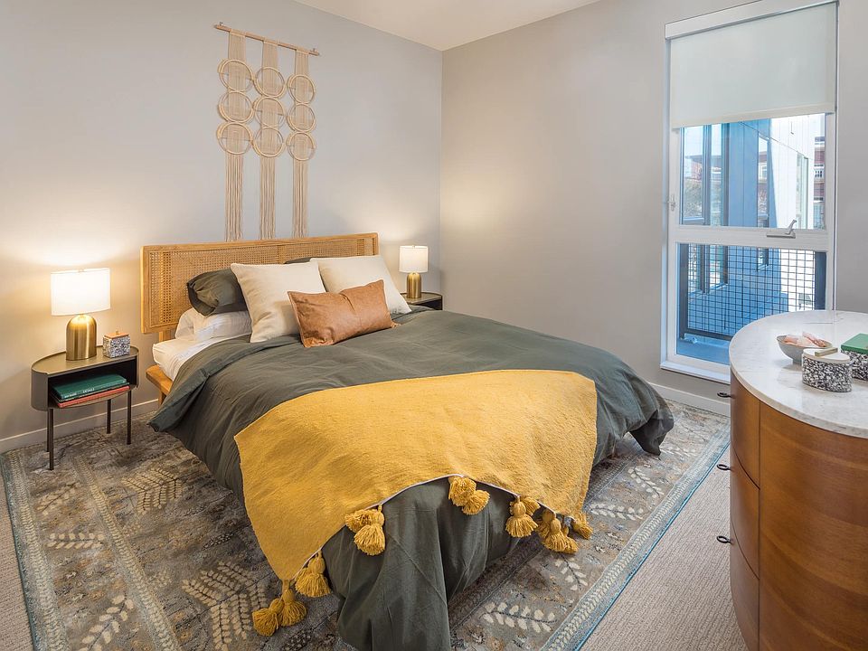 Spacious bedrooms with custom roller shades.