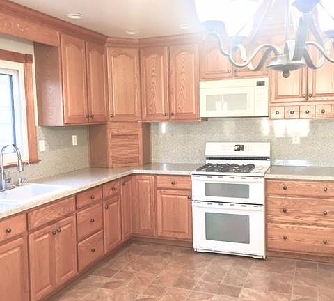 A lot of kitchen cabinets and counter to space & microwave